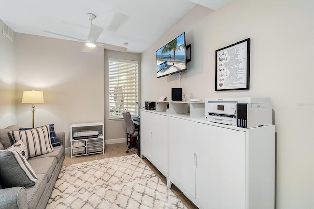 office area with visible vents, ceiling fan, baseboards, and light tile patterned floors