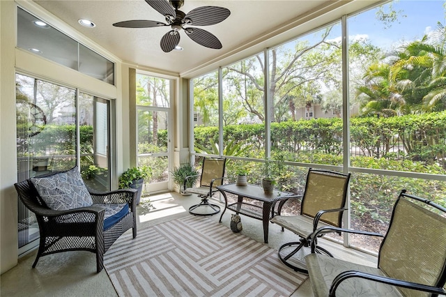 sunroom / solarium featuring ceiling fan