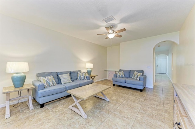 tiled living room with ceiling fan