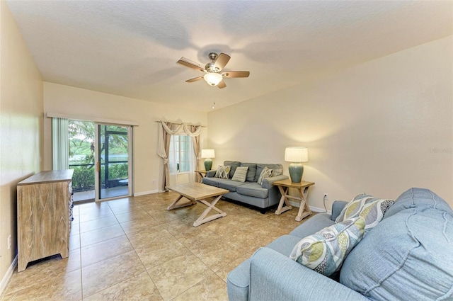 tiled living room featuring a textured ceiling and ceiling fan