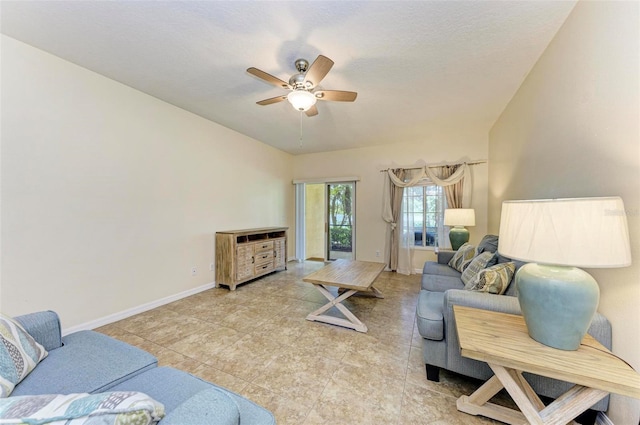 living room with a textured ceiling and ceiling fan