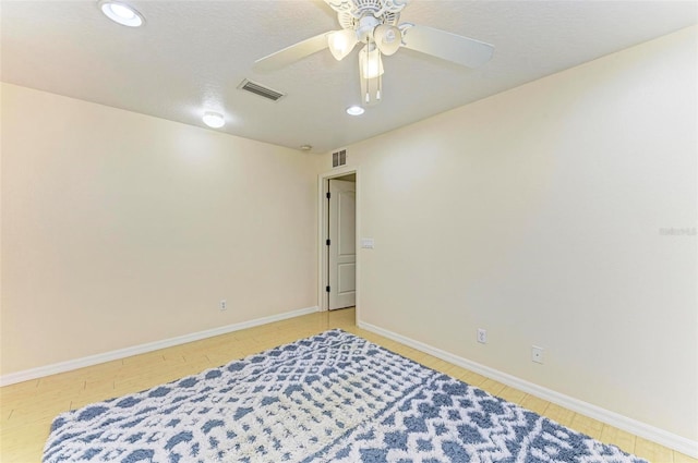 interior space with ceiling fan and a textured ceiling