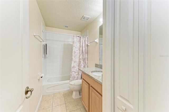 full bathroom featuring a textured ceiling, vanity, shower / tub combo with curtain, tile patterned flooring, and toilet