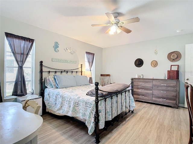 bedroom with ceiling fan and light wood-style flooring