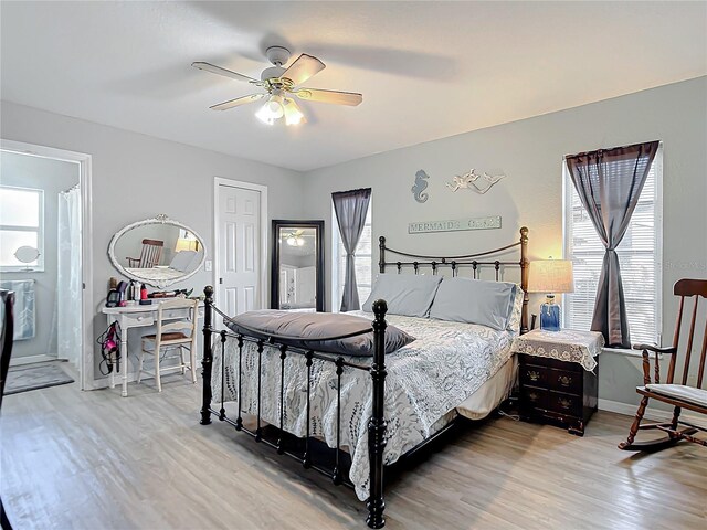 bedroom with a ceiling fan, baseboards, a closet, connected bathroom, and light wood-style floors