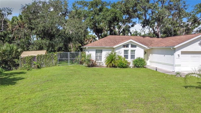 view of yard with fence and a garage