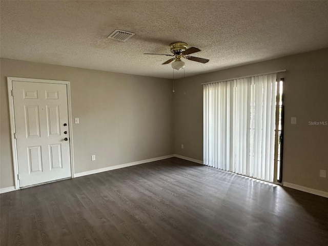 empty room with dark wood-type flooring, ceiling fan, and a textured ceiling