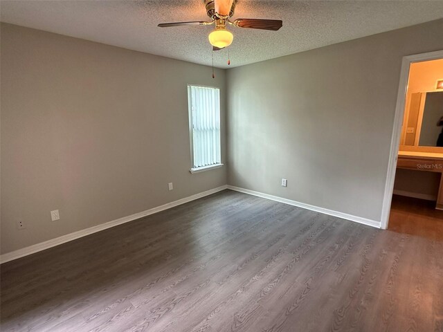 unfurnished bedroom with a textured ceiling, ceiling fan, hardwood / wood-style floors, and ensuite bathroom