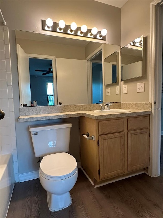 full bathroom with hardwood / wood-style floors, ceiling fan, toilet, and vanity