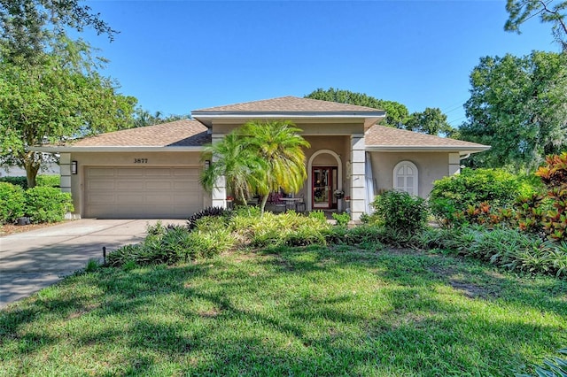 view of front facade with a garage and a front lawn