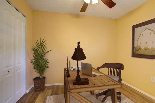 office space featuring hardwood / wood-style floors, a textured ceiling, and ceiling fan