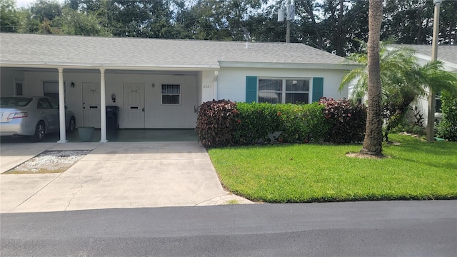 ranch-style house with a carport and a front yard