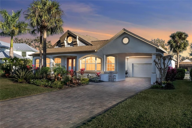 view of front of property featuring a lawn and a garage