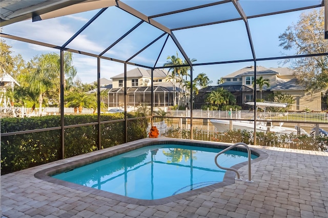 view of pool featuring glass enclosure and a patio area