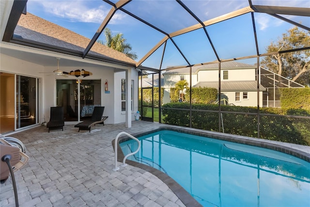 view of pool featuring a lanai, ceiling fan, and a patio area