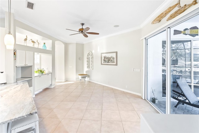 living room with ceiling fan, ornamental molding, and light tile patterned floors