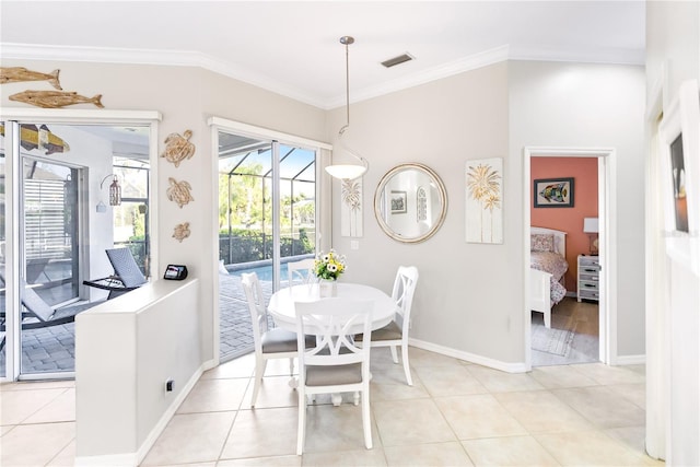 tiled dining room featuring ornamental molding