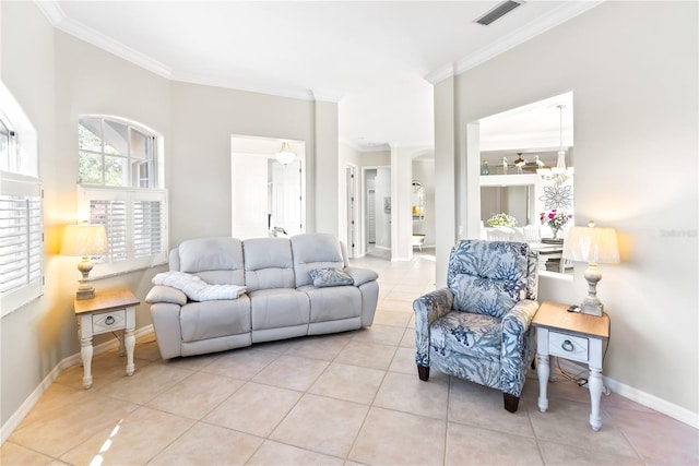 living room with ornamental molding, an inviting chandelier, and light tile patterned flooring