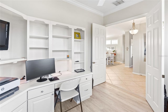 home office with built in desk, crown molding, and light hardwood / wood-style flooring