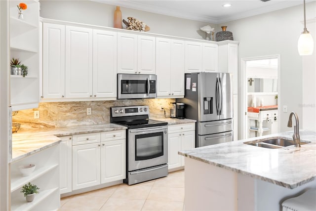 kitchen with hanging light fixtures, stainless steel appliances, white cabinetry, and sink