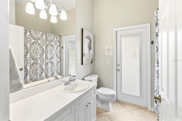 bathroom with tile patterned floors, toilet, curtained shower, and vanity