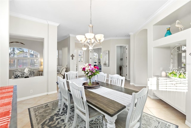 tiled dining room featuring a chandelier and crown molding