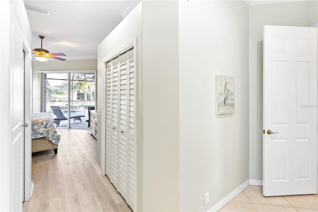 hall featuring light hardwood / wood-style floors and ornamental molding