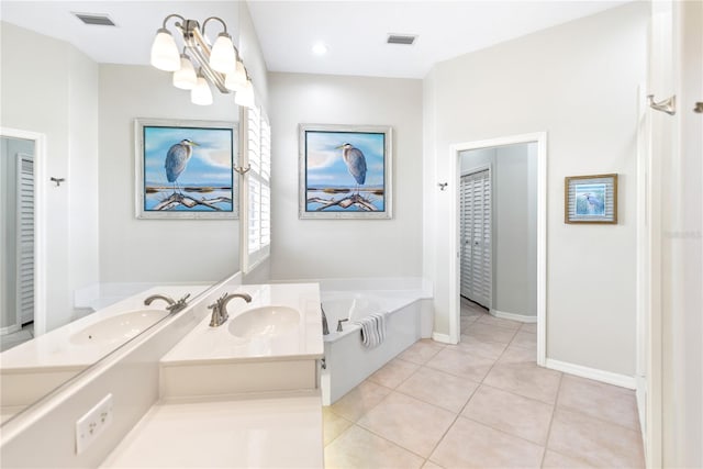 bathroom featuring tile patterned flooring, vanity, an inviting chandelier, and a bath