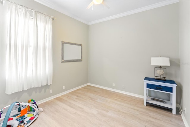 recreation room with ceiling fan, light hardwood / wood-style floors, and ornamental molding