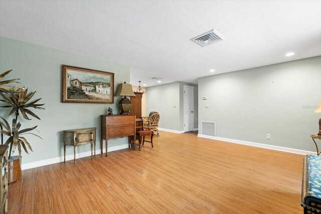 home office featuring light wood finished floors, baseboards, visible vents, and recessed lighting