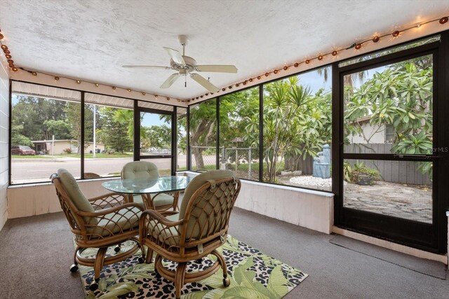 sunroom with plenty of natural light and ceiling fan