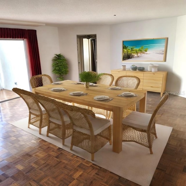 dining space with a textured ceiling and dark parquet floors