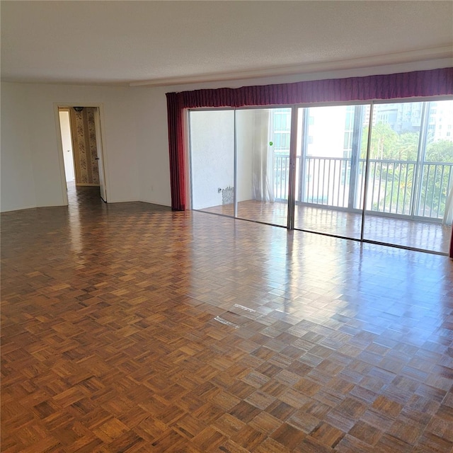 unfurnished room with dark parquet floors