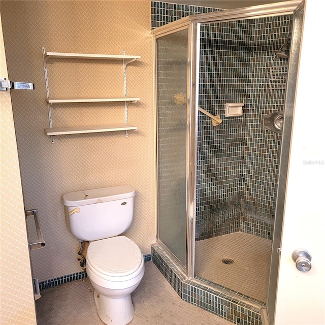 bathroom featuring toilet and an enclosed shower