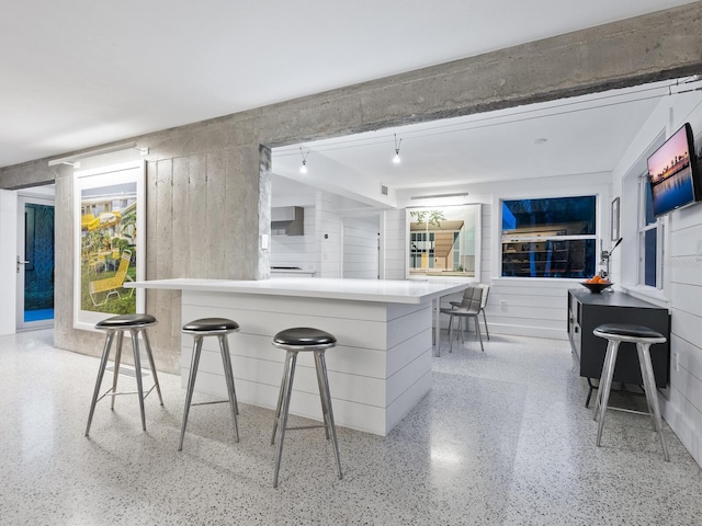 kitchen featuring a breakfast bar area and white cabinets