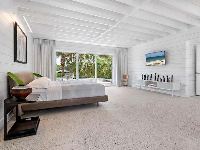 bedroom featuring beamed ceiling and wooden walls