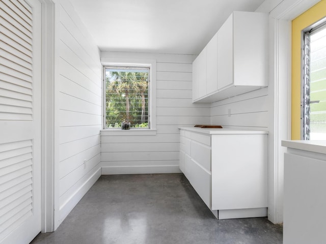 interior space featuring plenty of natural light and wood walls