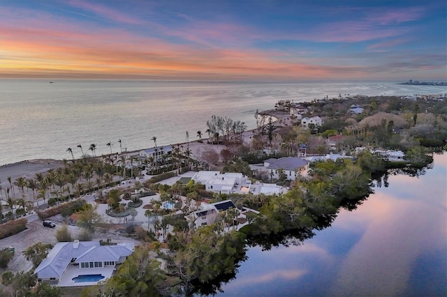 aerial view at dusk with a water view