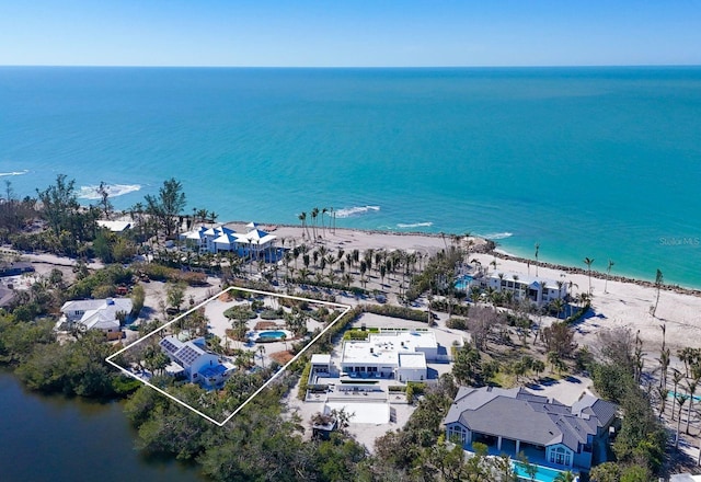 birds eye view of property with a beach view and a water view