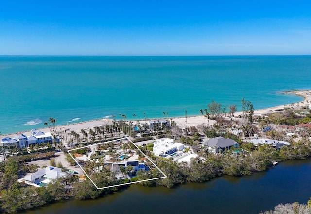 drone / aerial view featuring a view of the beach and a water view