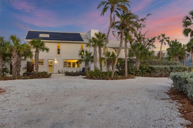 view of front of property featuring solar panels