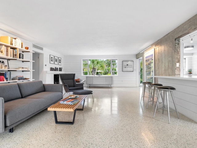 living room with wood walls