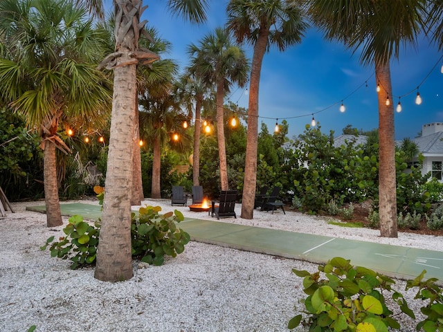 view of yard featuring an outdoor fire pit