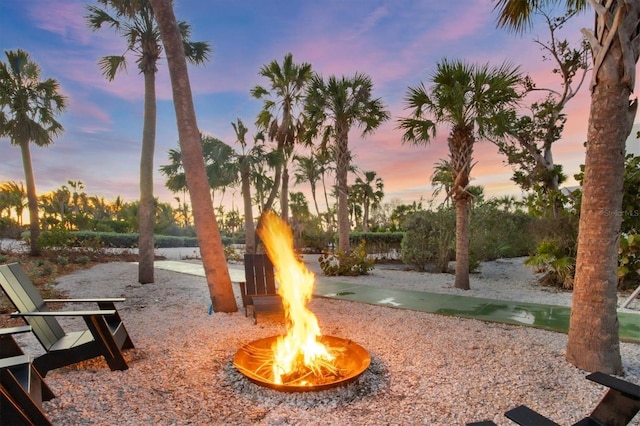 surrounding community featuring an outdoor fire pit