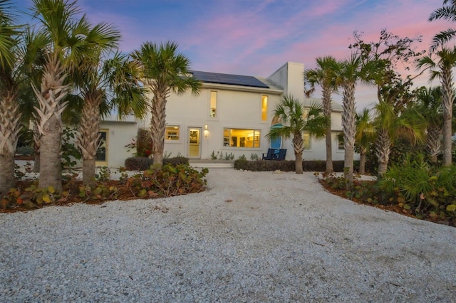 7665 Sanderling Rd, Sarasota, FL 34242 - mediterranean / spanish house featuring solar panels, driveway, and stucco siding