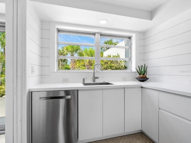 7665 Sanderling Rd, Sarasota, FL 34242 - kitchen featuring stainless steel dishwasher, speckle patterned floor, light countertops, and white cabinets