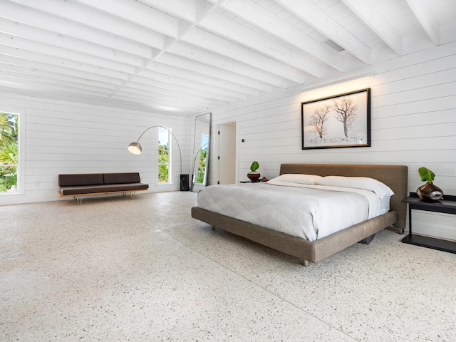 7665 Sanderling Rd, Sarasota, FL 34242 - bedroom featuring wooden walls, beam ceiling, and speckled floor