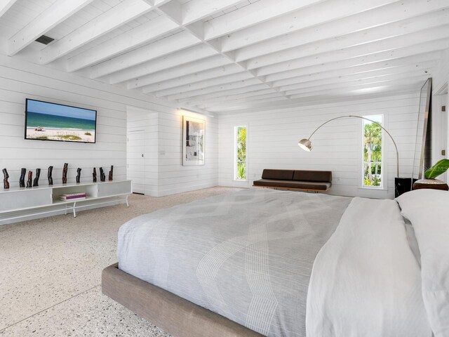 7665 Sanderling Rd, Sarasota, FL 34242 - bedroom featuring speckle patterned floor, beamed ceiling, and wooden walls