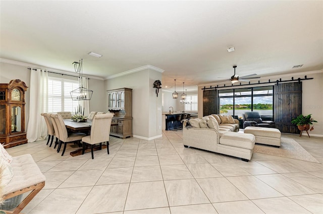 living room featuring ceiling fan with notable chandelier, ornamental molding, and a healthy amount of sunlight