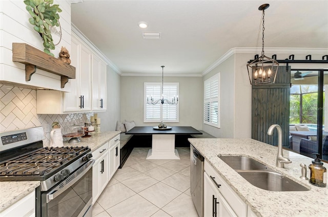 kitchen featuring white cabinets, decorative light fixtures, stainless steel appliances, a chandelier, and sink